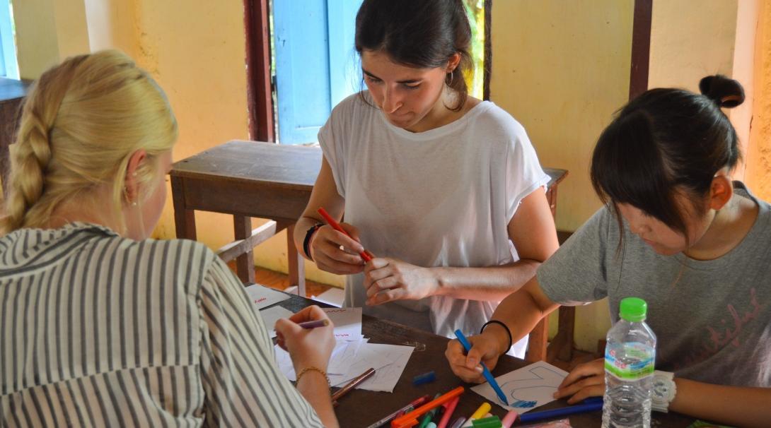 As part of their Projects Abroad service learning project for middle school students in Cambodia, volunteers prepare an activity for a kindergarten class. Part of the Experiential Learning model in Cambodia for middle school students, is for students to help by preparing activities in a kindergarten.